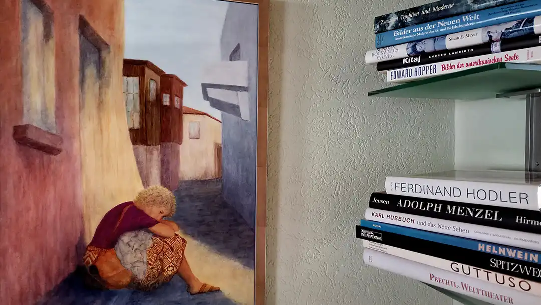 A painting and art books in the foyer